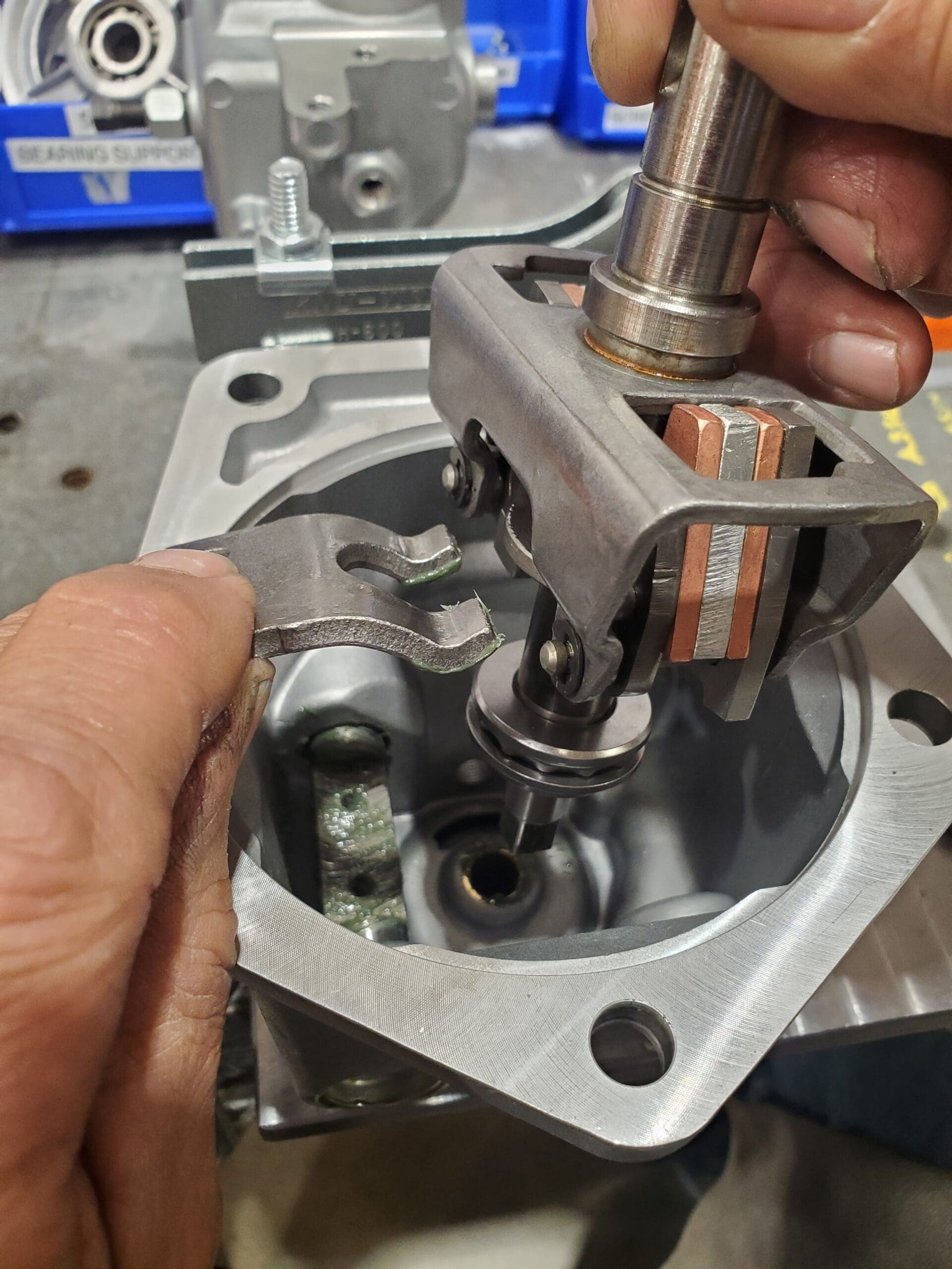 A person skillfully adjusts a valve using a specialized tool, demonstrating precision and technical expertise.