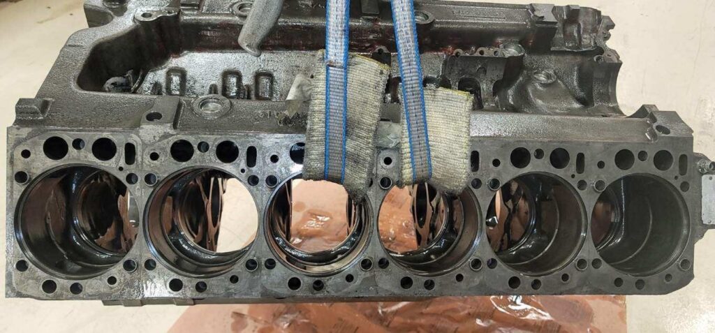A clean engine block, looks freshly washed and cleaned. It is no longer in it's original rusty condition