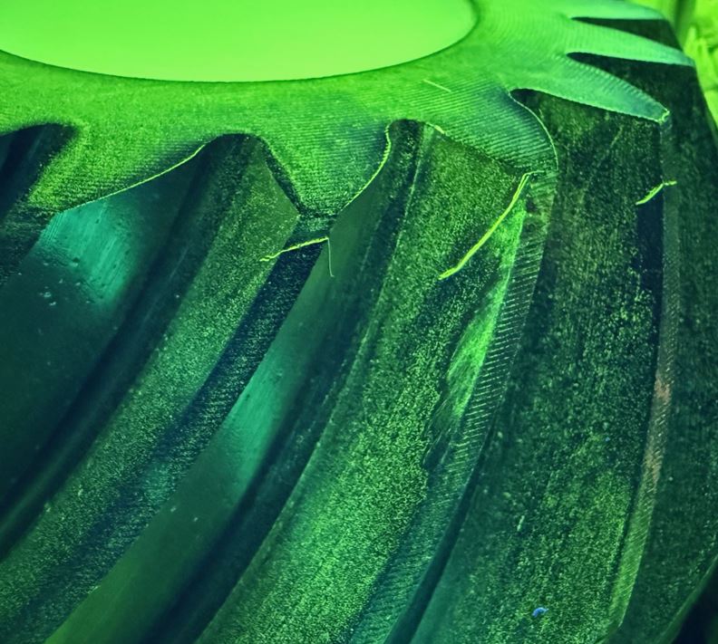 Detailed close-up of a green plastic item, highlighting its surface and vibrant hue.