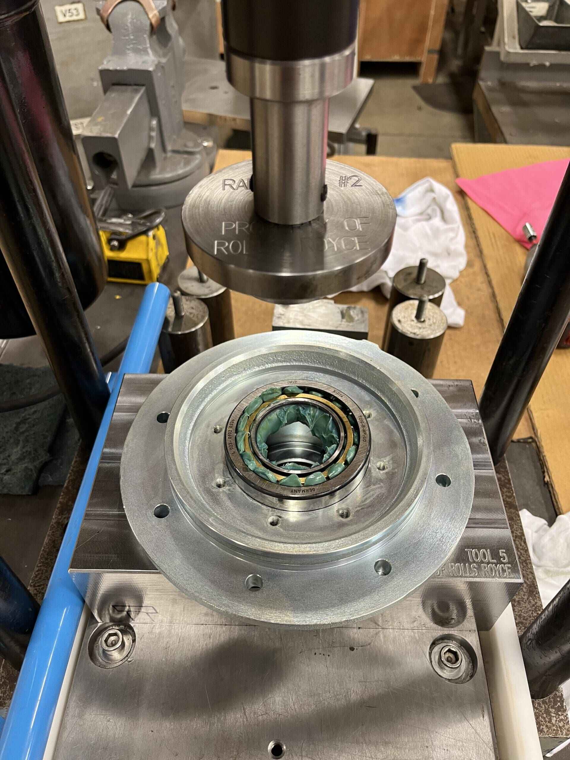 A machine fabricates a metal component using a wheel, showcasing precision engineering in action.